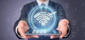 businessman-holding-wifi-icon-with-stats-binary-code-1-768x361